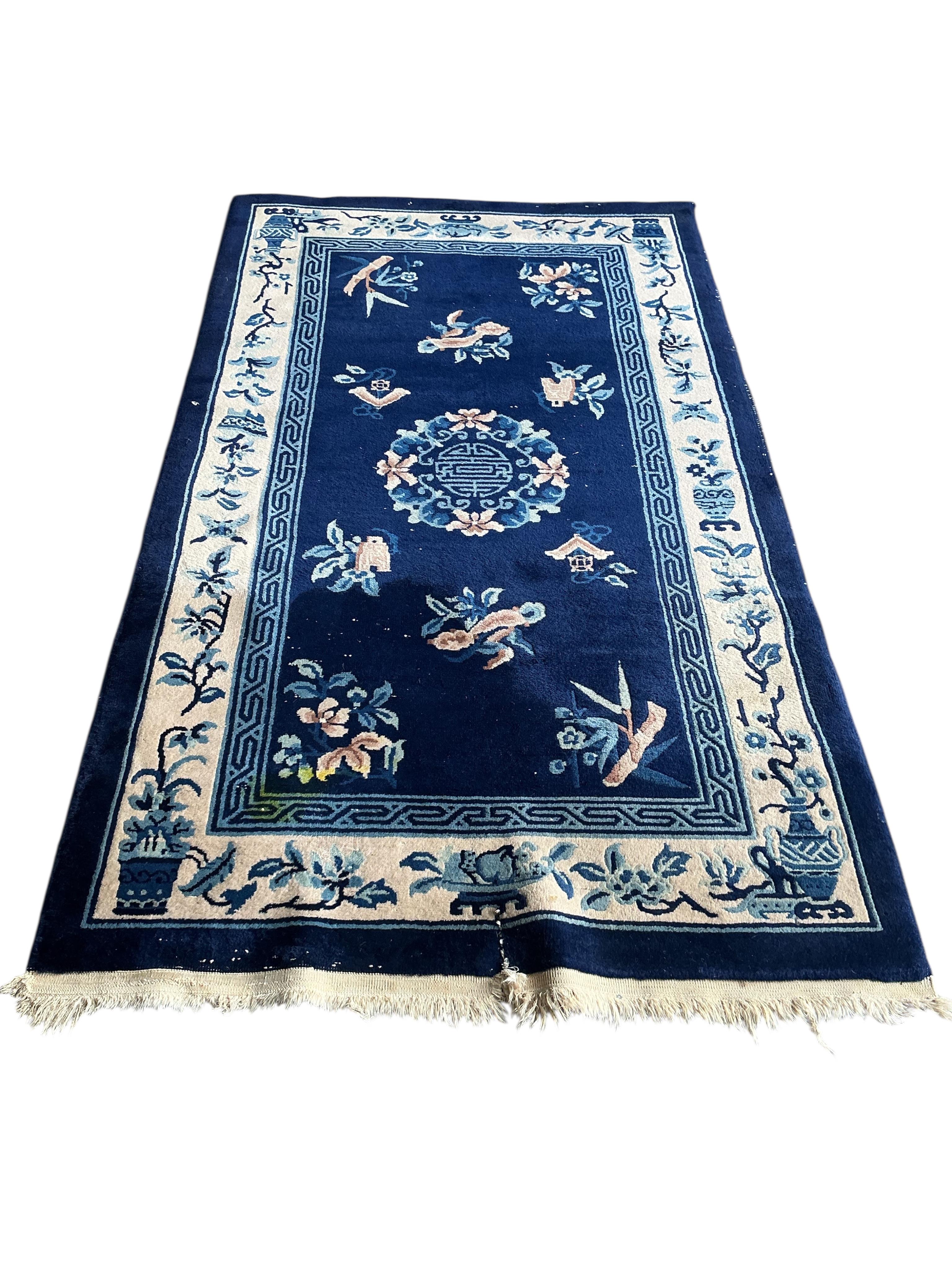 A Chinese blue ground rug, 210 x 124cm